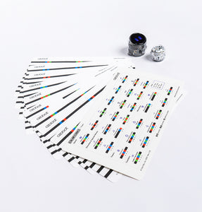 Sheets of Ozobot Color Code Stickers spread out, with Ari STEM robots ready for coding play