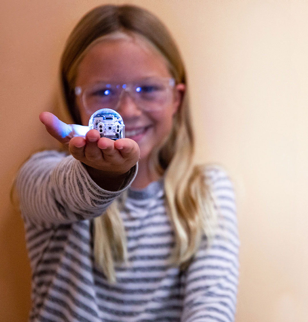 Child learning to code with Evo coding robot during after-school activity